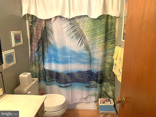 a living room with furniture a flat screen tv and a floor to ceiling window