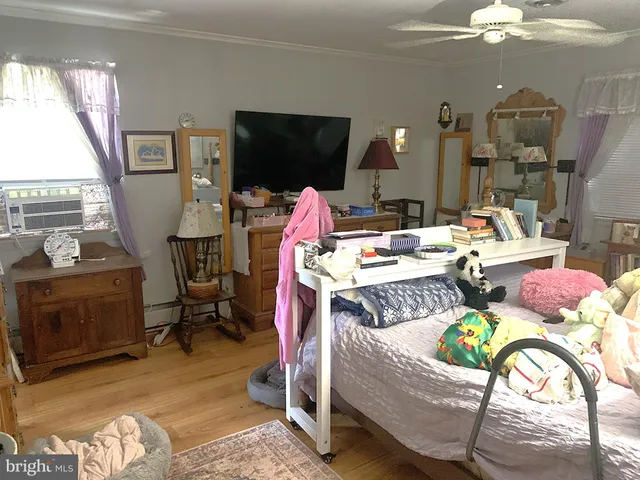 a bedroom with a bed and flat screen tv