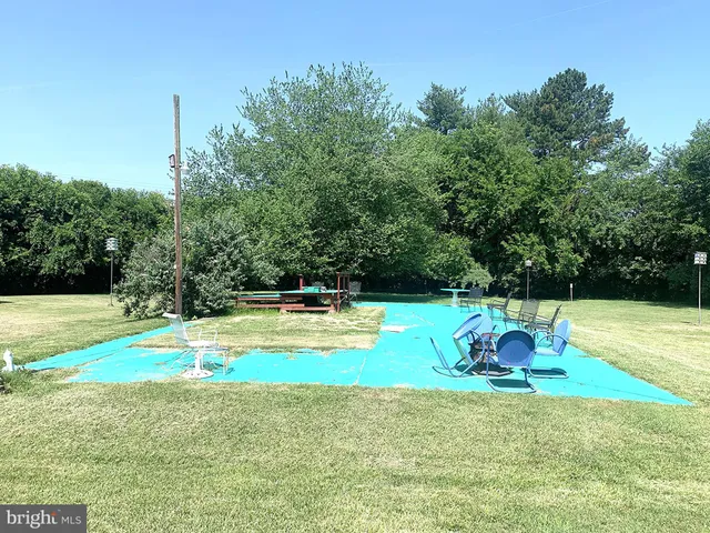 a view of a swimming pool with a yard