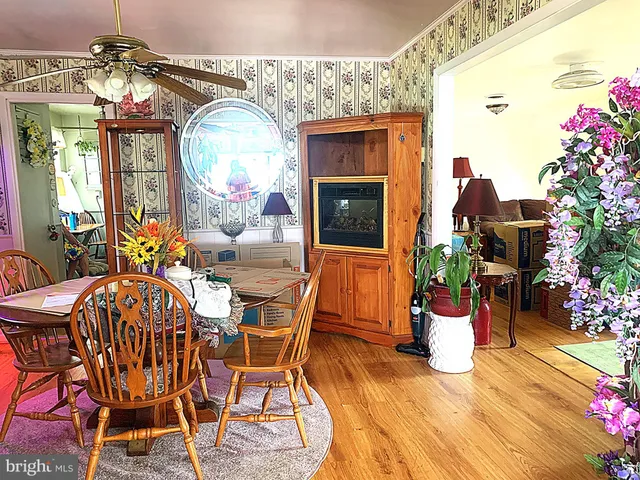 a view of a dining room with furniture and a chandelier