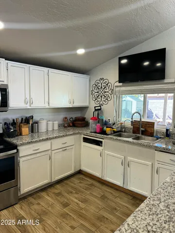 a kitchen with stainless steel appliances a stove a sink and a microwave