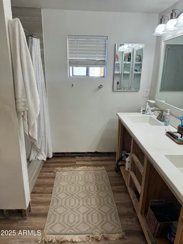 a bathroom with a sink double vanity and a mirror