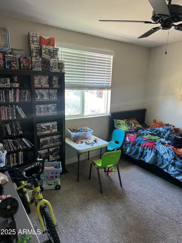 a bedroom with a bed next to a window