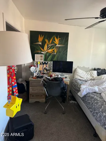 a bedroom with furniture and a flat screen tv