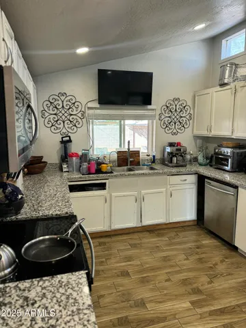 a kitchen with a sink and a stove top oven