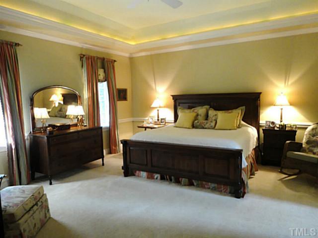 1108 Mersey Lane Raleigh, NC 27615 - Photo 12 of 25 a bedroom with a bed and a walk in closet