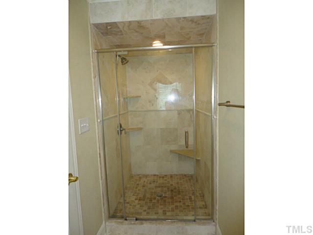 1108 Mersey Lane Raleigh, NC 27615 - Photo 15 of 25 a bathroom with a glass shower door
