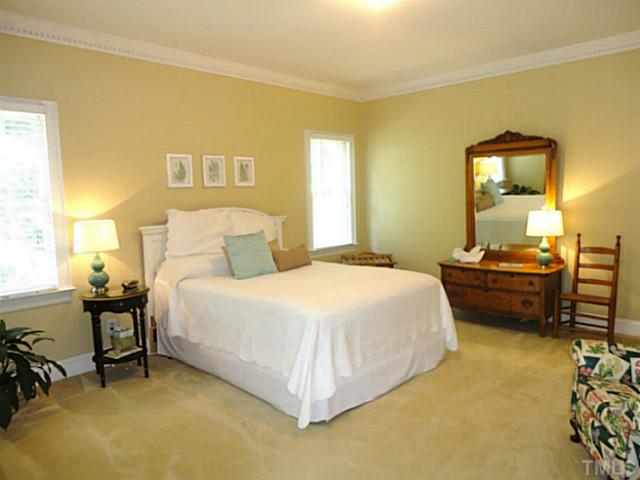 1108 Mersey Lane Raleigh, NC 27615 - Photo 19 of 25 a bedroom with a bed and a table in it