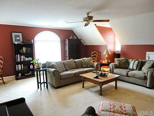 1108 Mersey Lane Raleigh, NC 27615 - Photo 20 of 25 a living room with furniture and a wooden floor