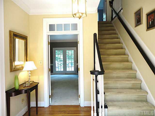 1108 Mersey Lane Raleigh, NC 27615 - Photo 3 of 25 a view of an entryway with wooden floor and a chandelier