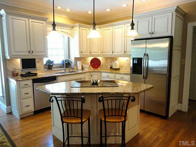 1108 Mersey Lane Raleigh, NC 27615 - Photo 6 of 25 a kitchen with stainless steel appliances granite countertop a sink a stove and a refrigerator