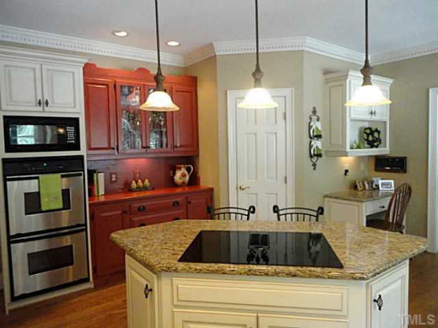 1108 Mersey Lane Raleigh, NC 27615 - Photo 7 of 25 a kitchen with a sink stove and refrigerator