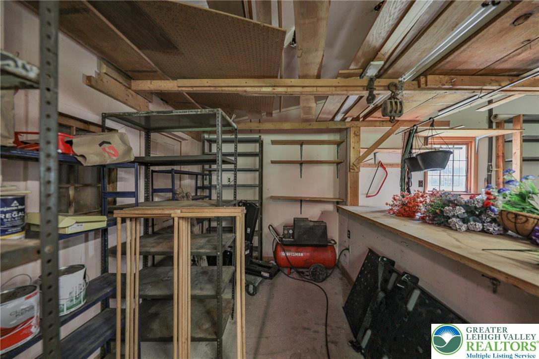 331 Cranberry Creek Road Cresco, PA 18326 - Photo 39 of 95 A versatile workshop area features ample built-in shelving for organized storage.