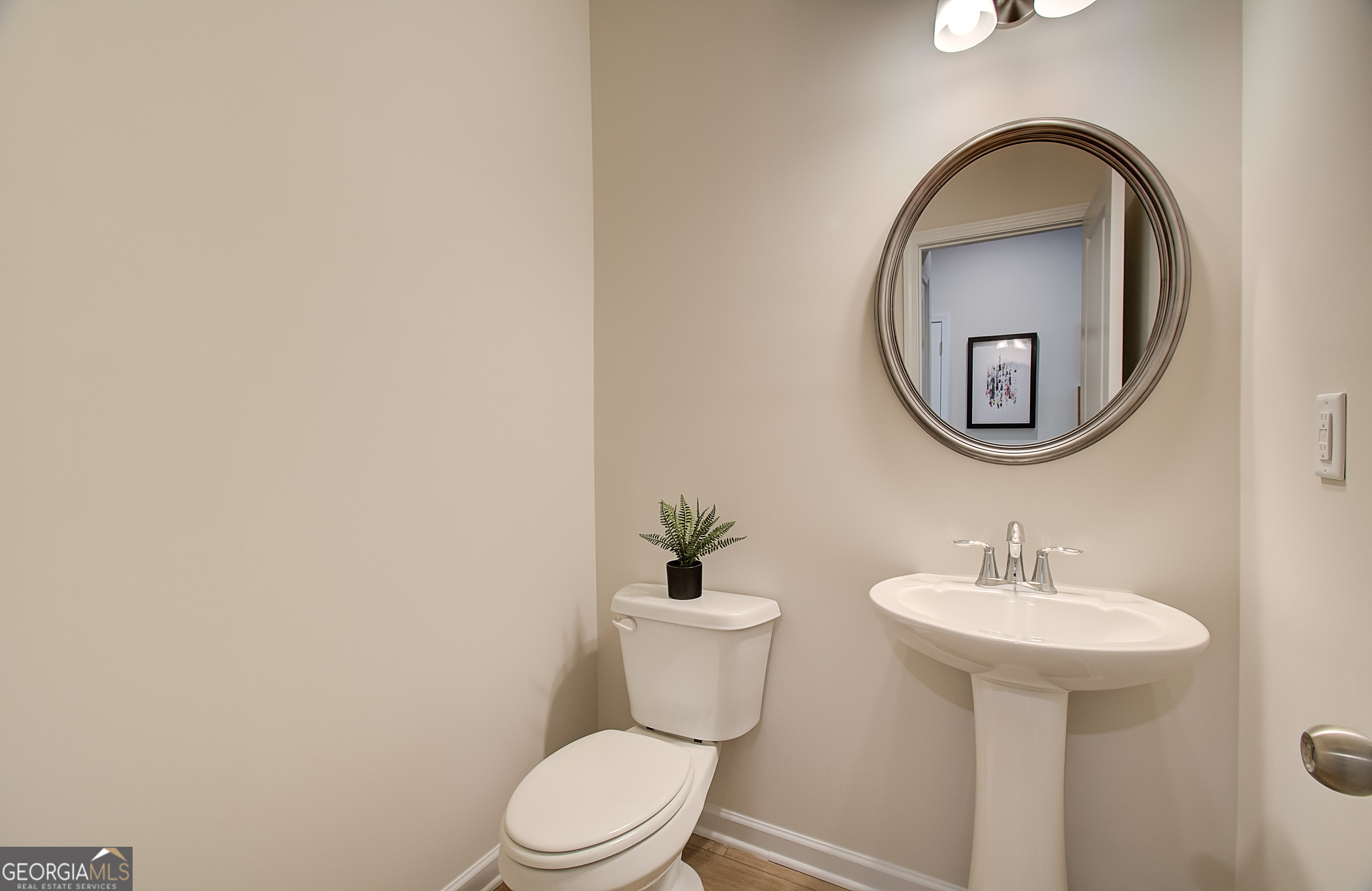 4581 Ajo Walk, Unit HOMESITE 22 Atlanta, GA 30331 - Photo 12 of 18 a bathroom with a toilet sink and mirror