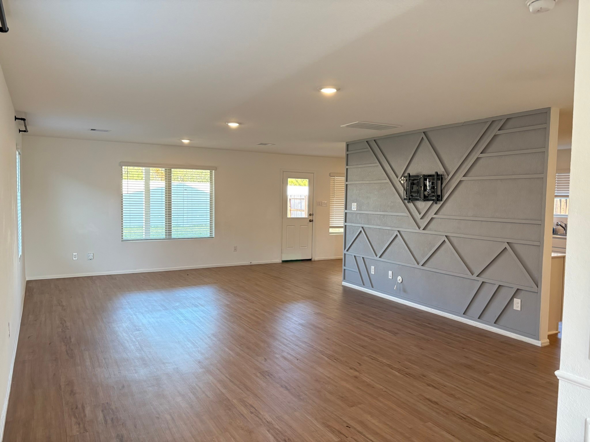 21911 Scopeto Lane New Caney, TX 77357 - Photo 3 of 14 an empty room with wooden floor entryway and windows