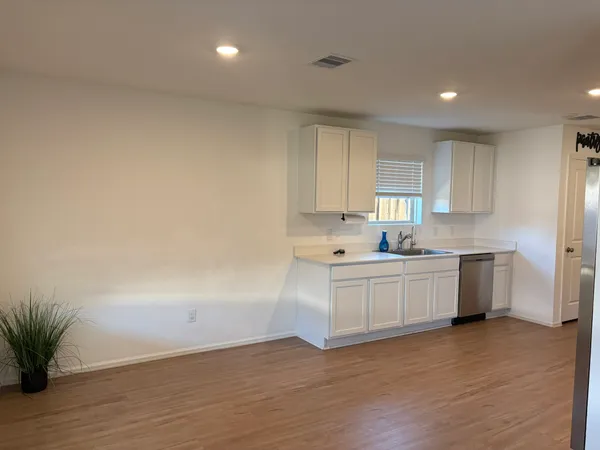 a kitchen with sink and cabinets