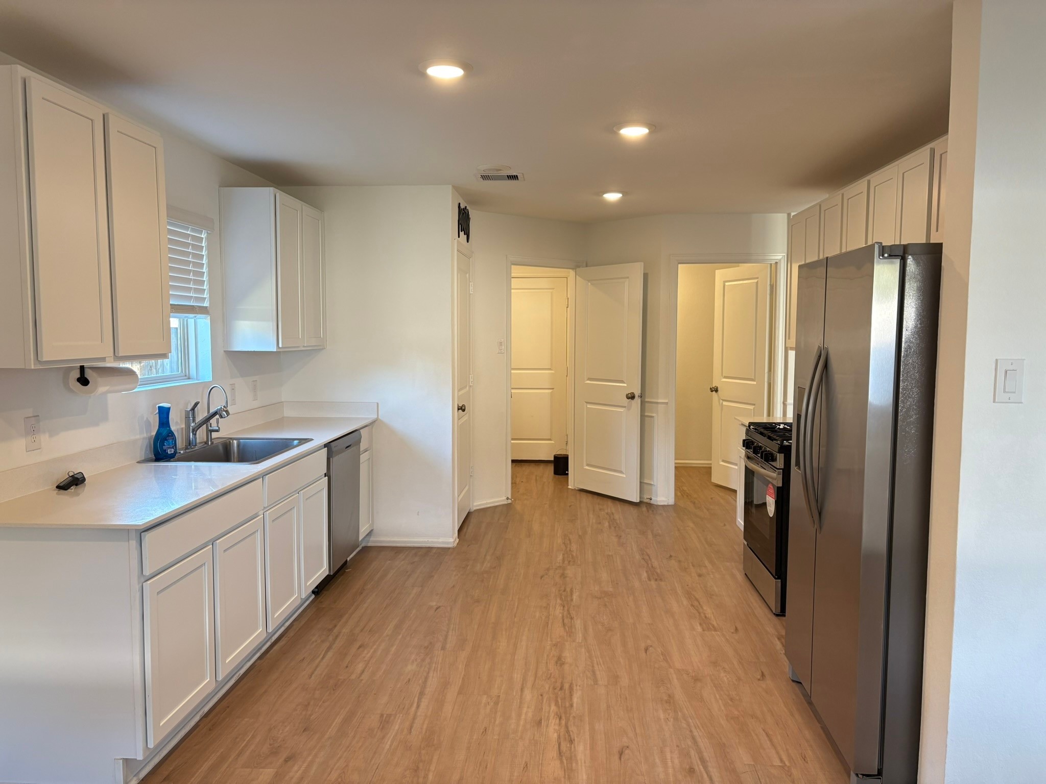 21911 Scopeto Lane New Caney, TX 77357 - Photo 6 of 14 a view of a kitchen with a sink and refrigerator