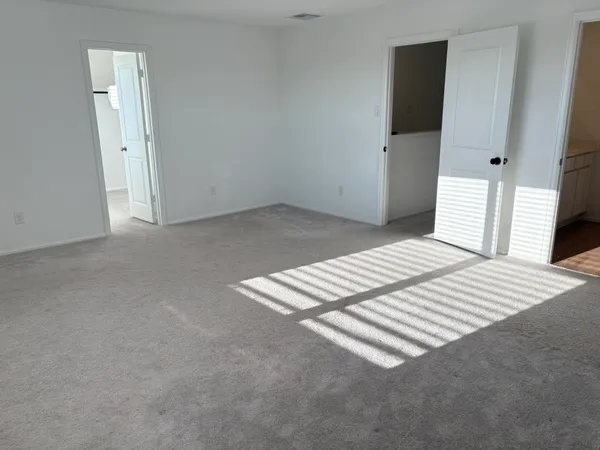 a view of wooden floor and windows in a room