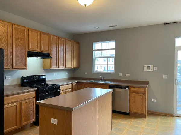 a kitchen that has a sink and a stove in it