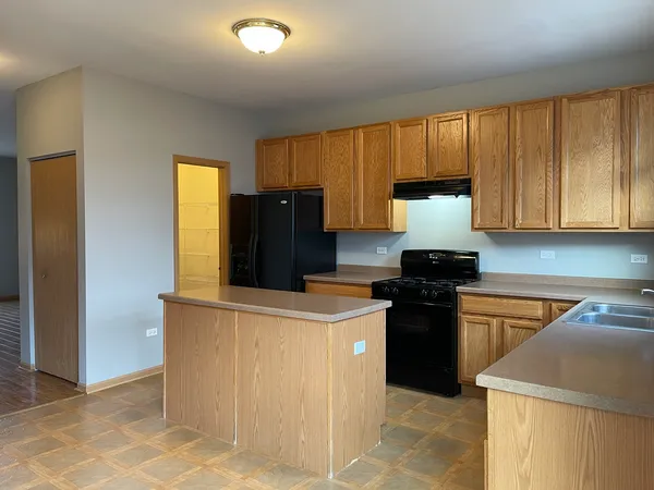 a kitchen with a refrigerator stove and cabinets