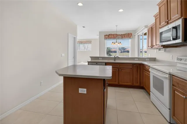 a kitchen with stainless steel appliances granite countertop a sink microwave and cabinets
