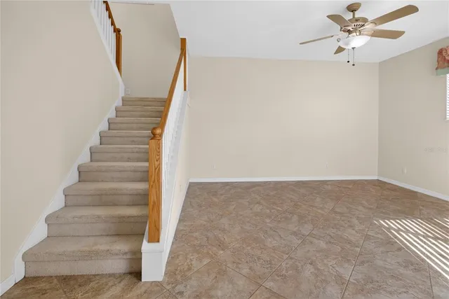 a large kitchen with stainless steel appliances granite countertop a sink and a refrigerator