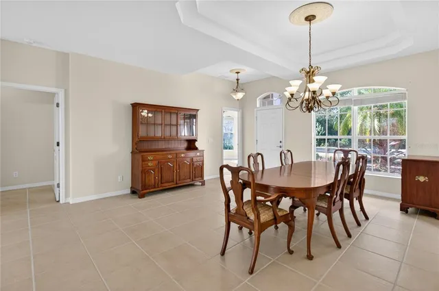 a view of a dining room with furniture and chandelier