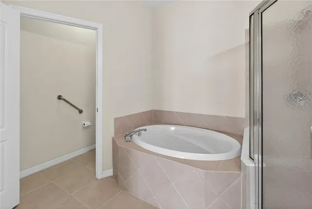 a bathroom with a granite countertop sink a toilet a mirror and shower