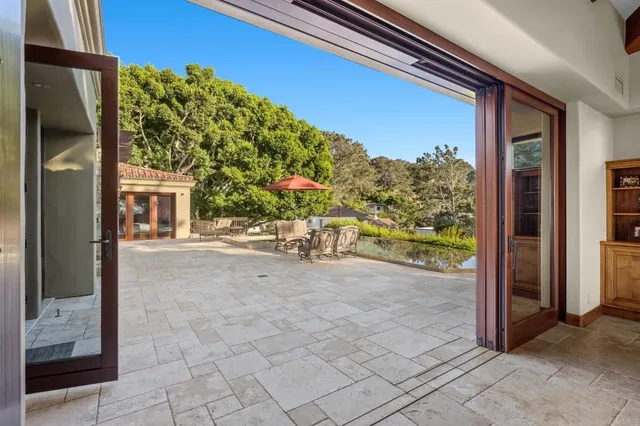 a dining room with furniture a rug and a large window