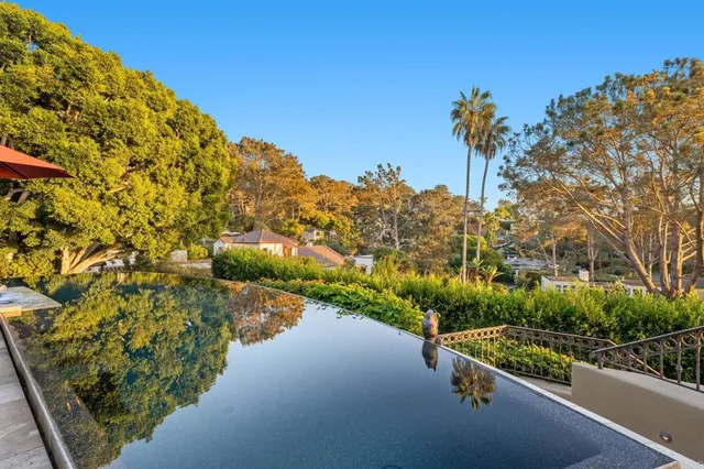 a dining room with furniture a rug and a large window