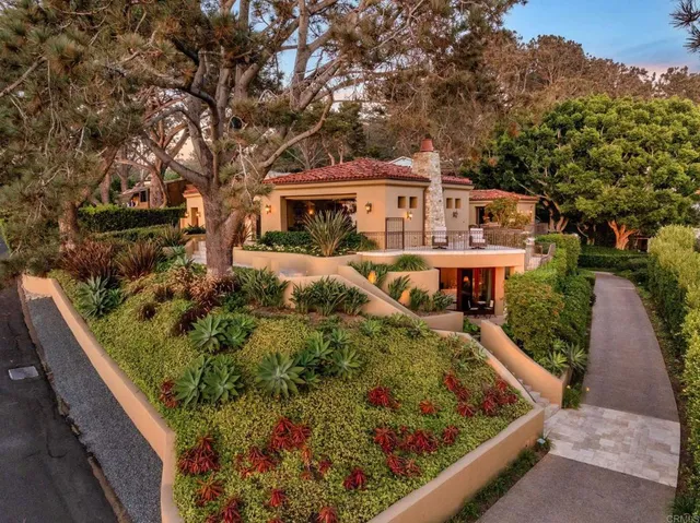 an aerial view of ocean and residential houses with outdoor space