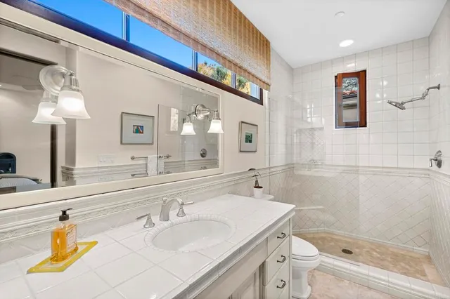 a roof deck with table and chairs and wooden fence