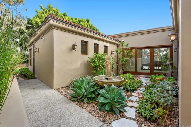 a view of a patio with a table and chairs under an umbrella