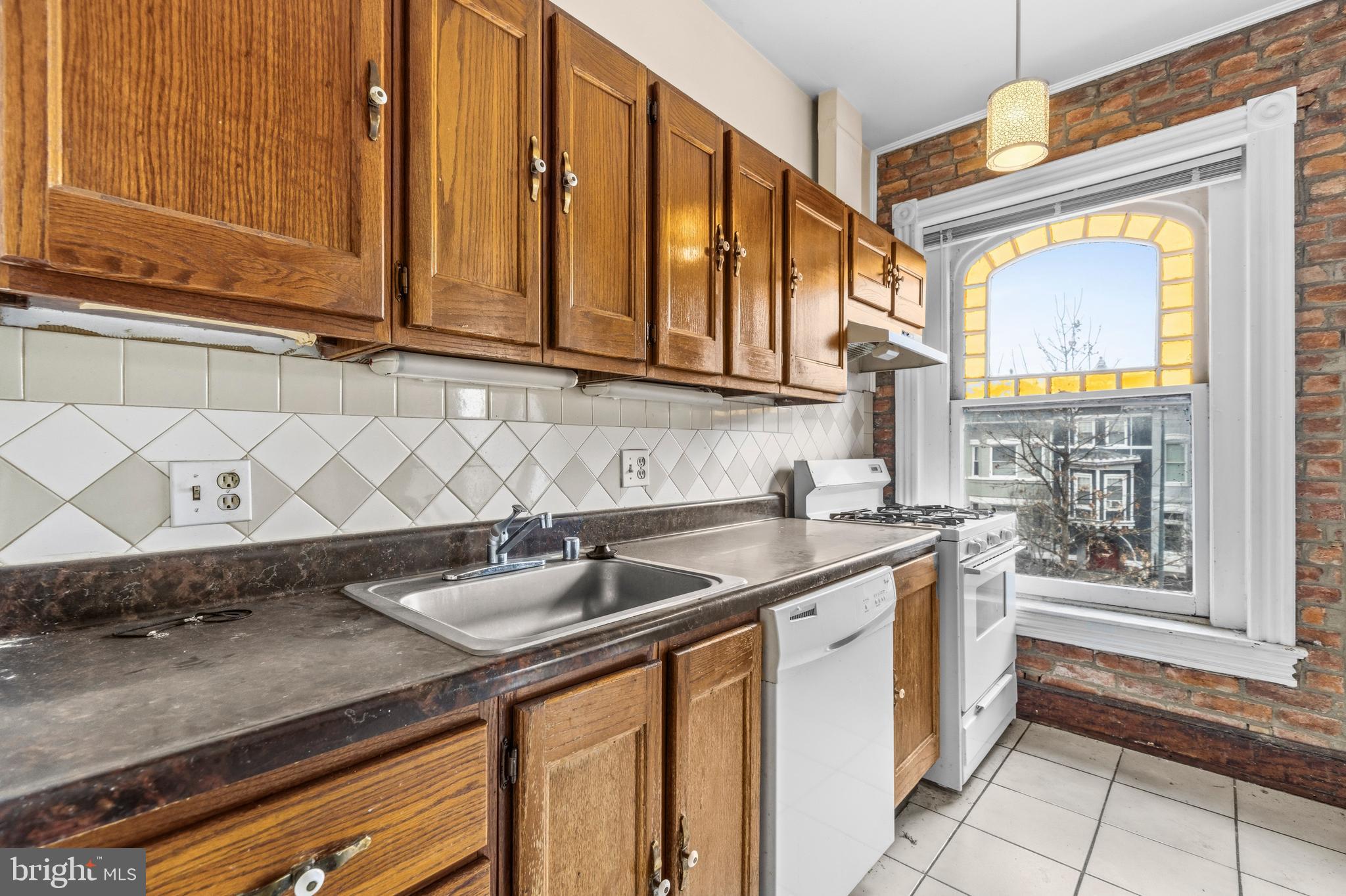 1920 11th Street Northwest Washington, DC 20001 - Photo 31 of 55 a kitchen with stainless steel appliances granite countertop a sink a stove and cabinets