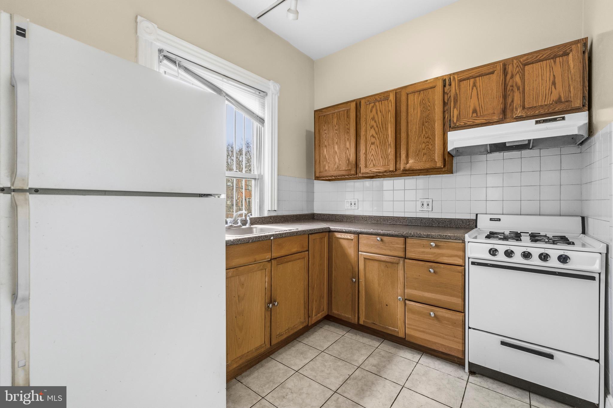 1920 11th Street Northwest Washington, DC 20001 - Photo 39 of 55 a kitchen with stainless steel appliances granite countertop a refrigerator sink and stove