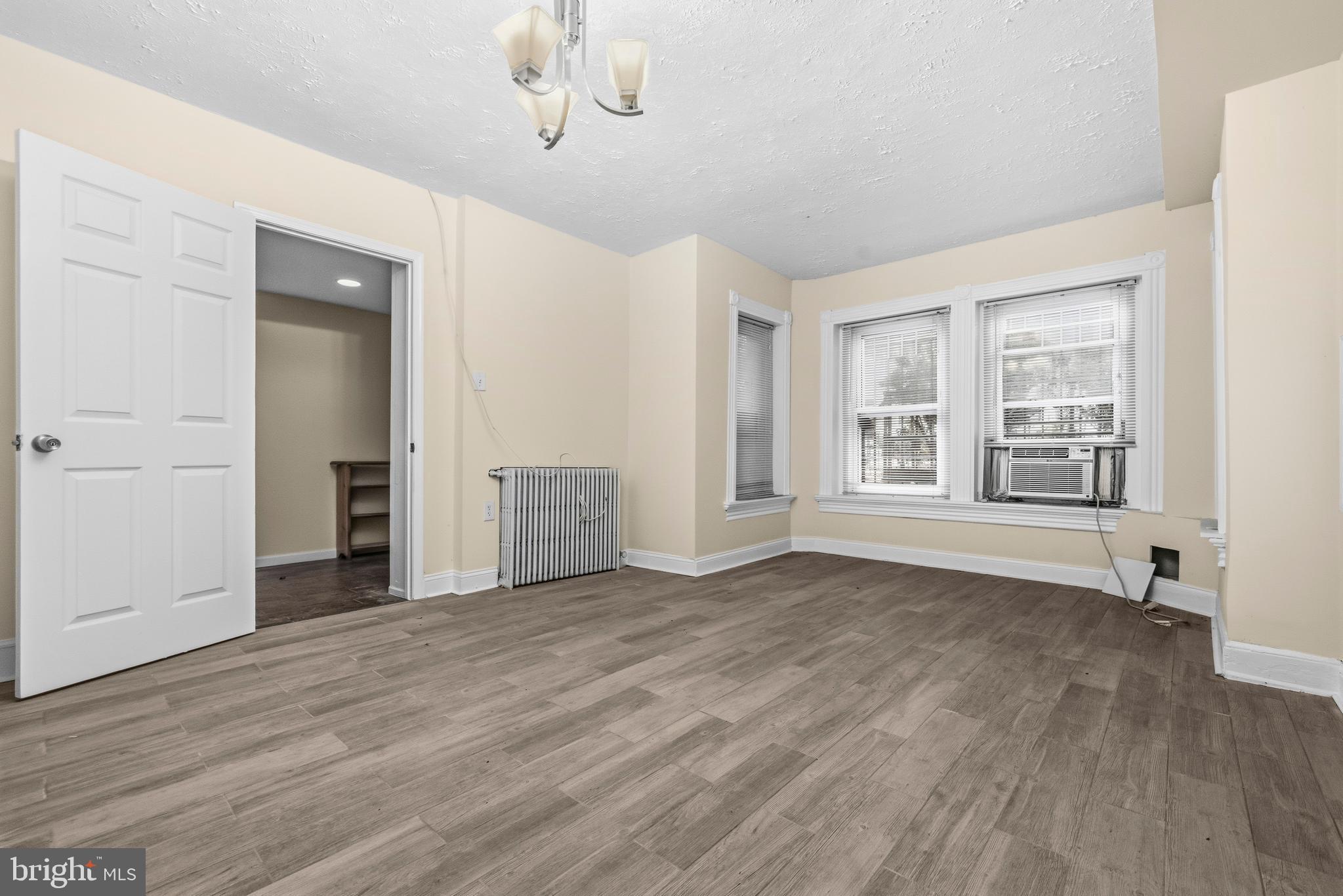 1920 11th Street Northwest Washington, DC 20001 - Photo 43 of 55 a view of an empty room with a window and wooden floor