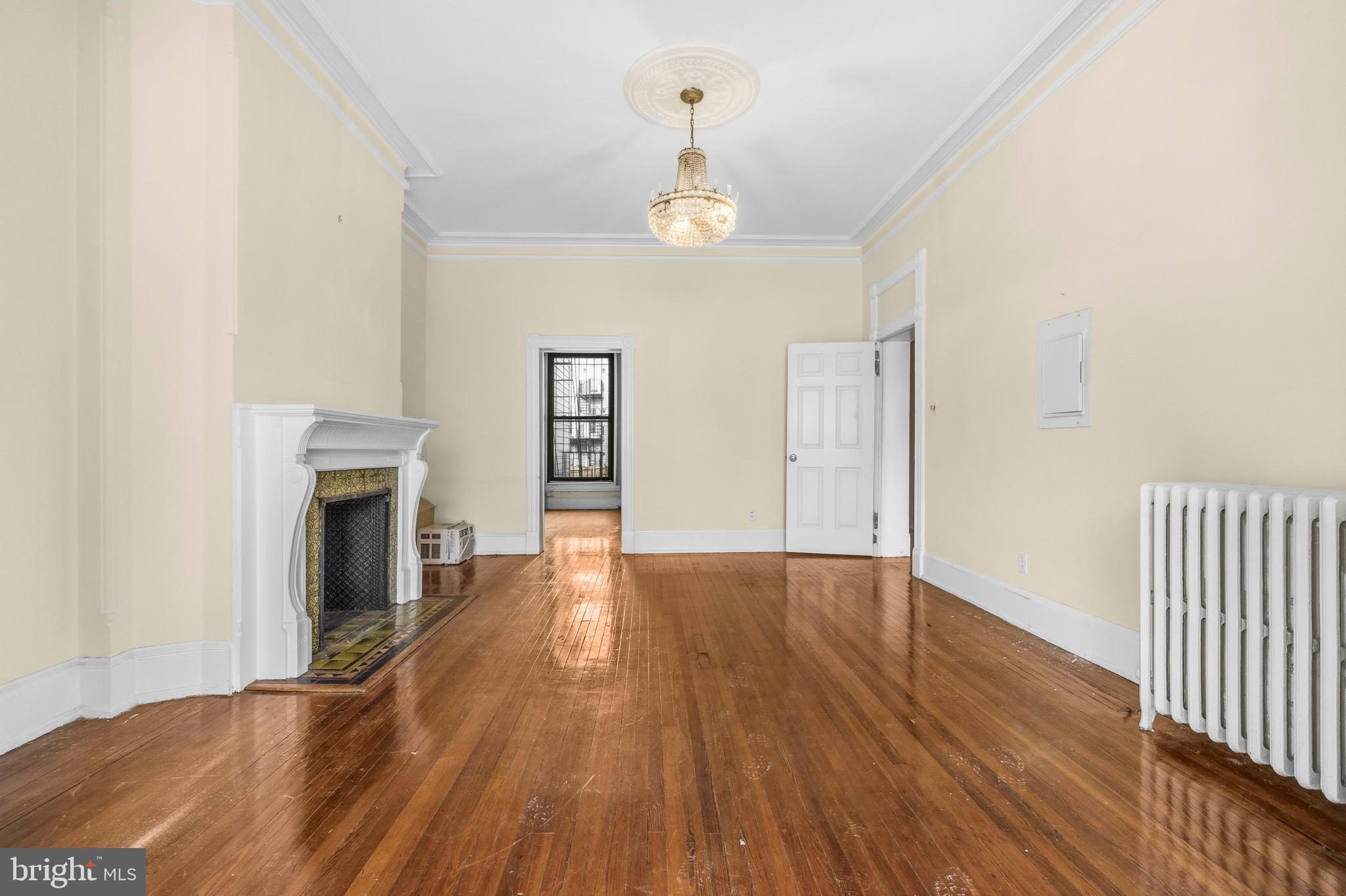 1920 11th Street Northwest Washington, DC 20001 - Photo 5 of 55 an empty room with wooden floor fireplace and windows