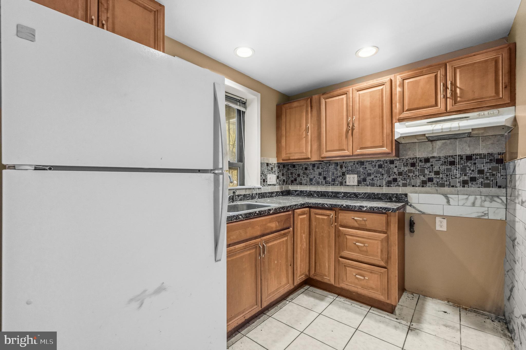 1920 11th Street Northwest Washington, DC 20001 - Photo 10 of 55 a kitchen with stainless steel appliances granite countertop a refrigerator sink and cabinets