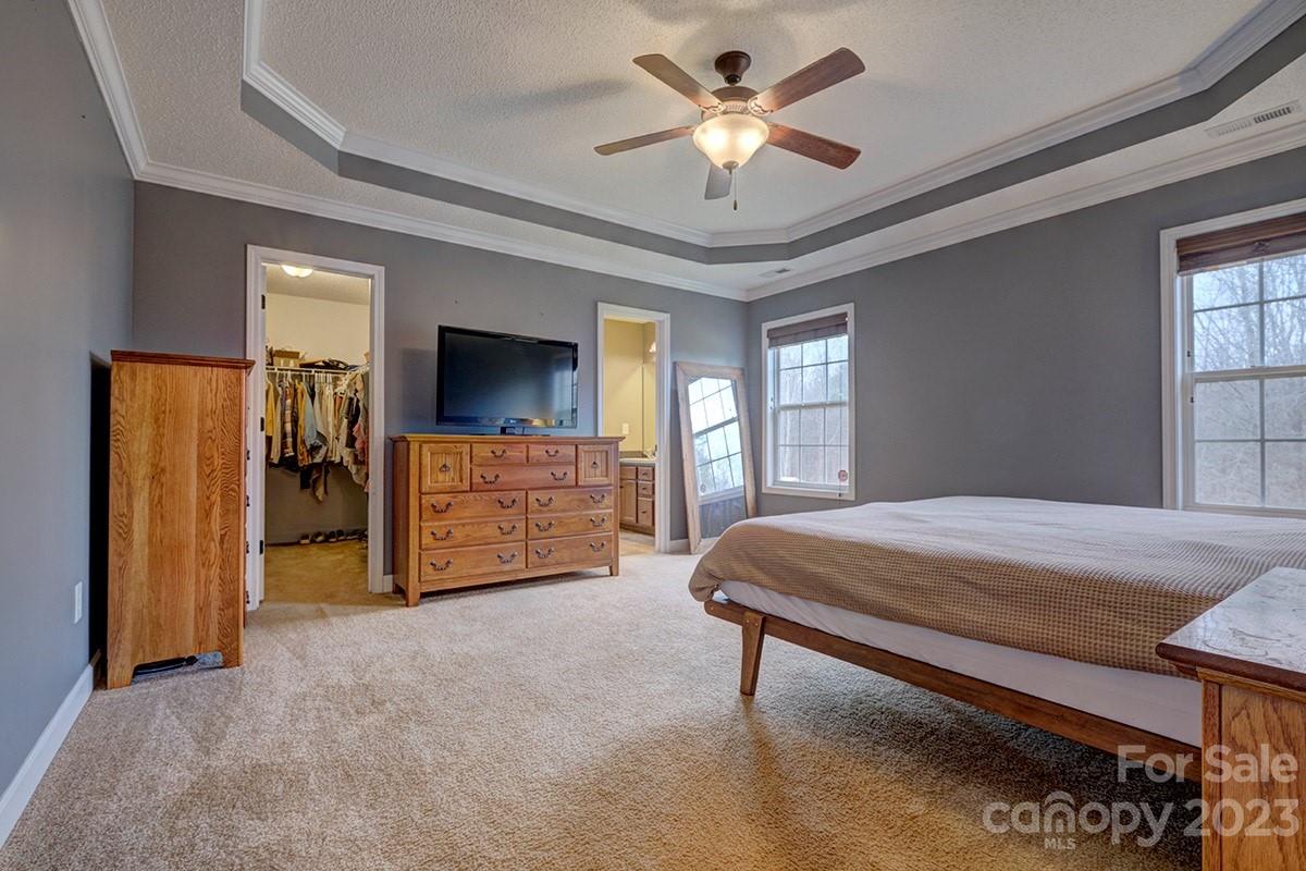 276 Springlake Road, Unit 6 York, SC 29745 - Photo 13 of 31 a bedroom with a bed and a chandelier