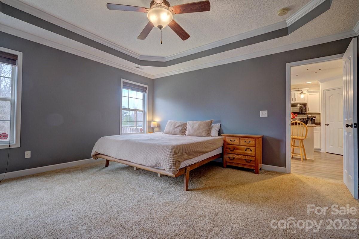 276 Springlake Road, Unit 6 York, SC 29745 - Photo 14 of 31 a spacious bedroom with a bed and a chandelier