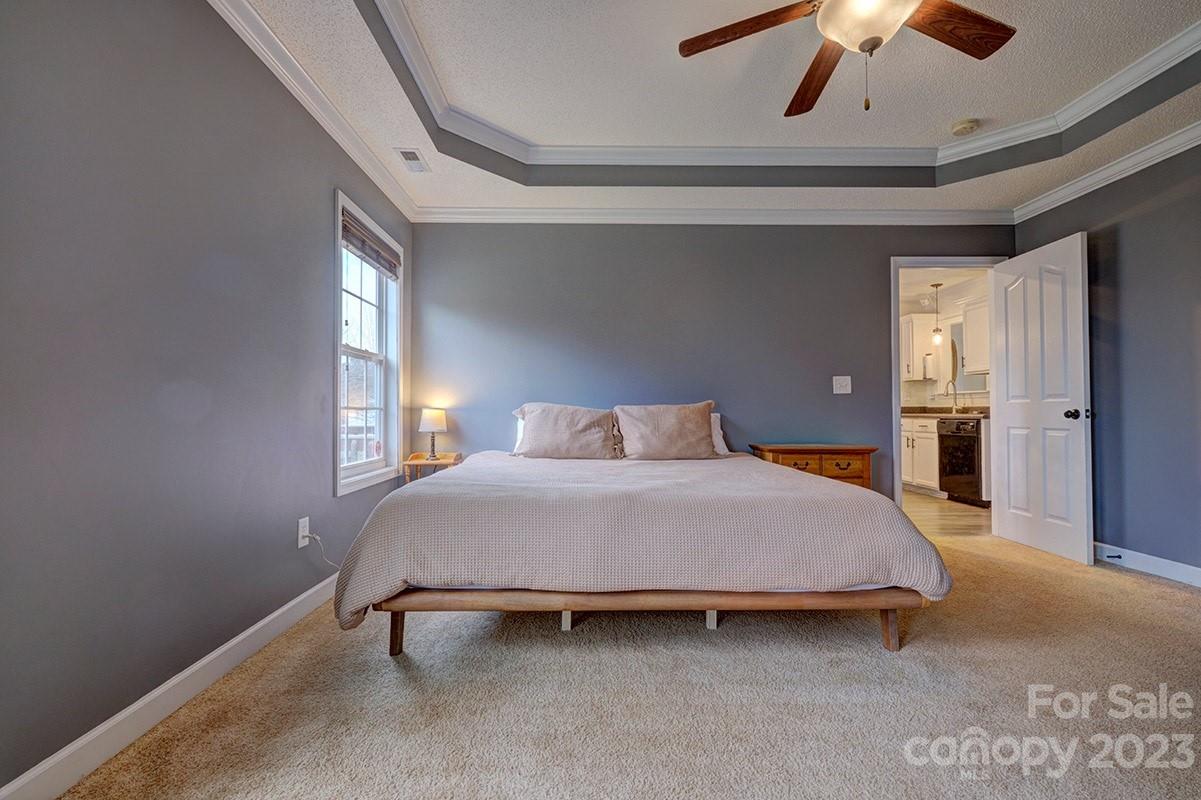 276 Springlake Road, Unit 6 York, SC 29745 - Photo 15 of 31 a bedroom with a bed and a chandelier fan