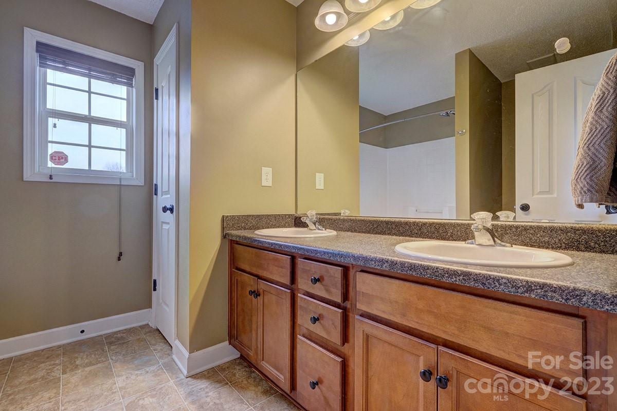 276 Springlake Road, Unit 6 York, SC 29745 - Photo 16 of 31 a bathroom with a granite countertop sink and a mirror