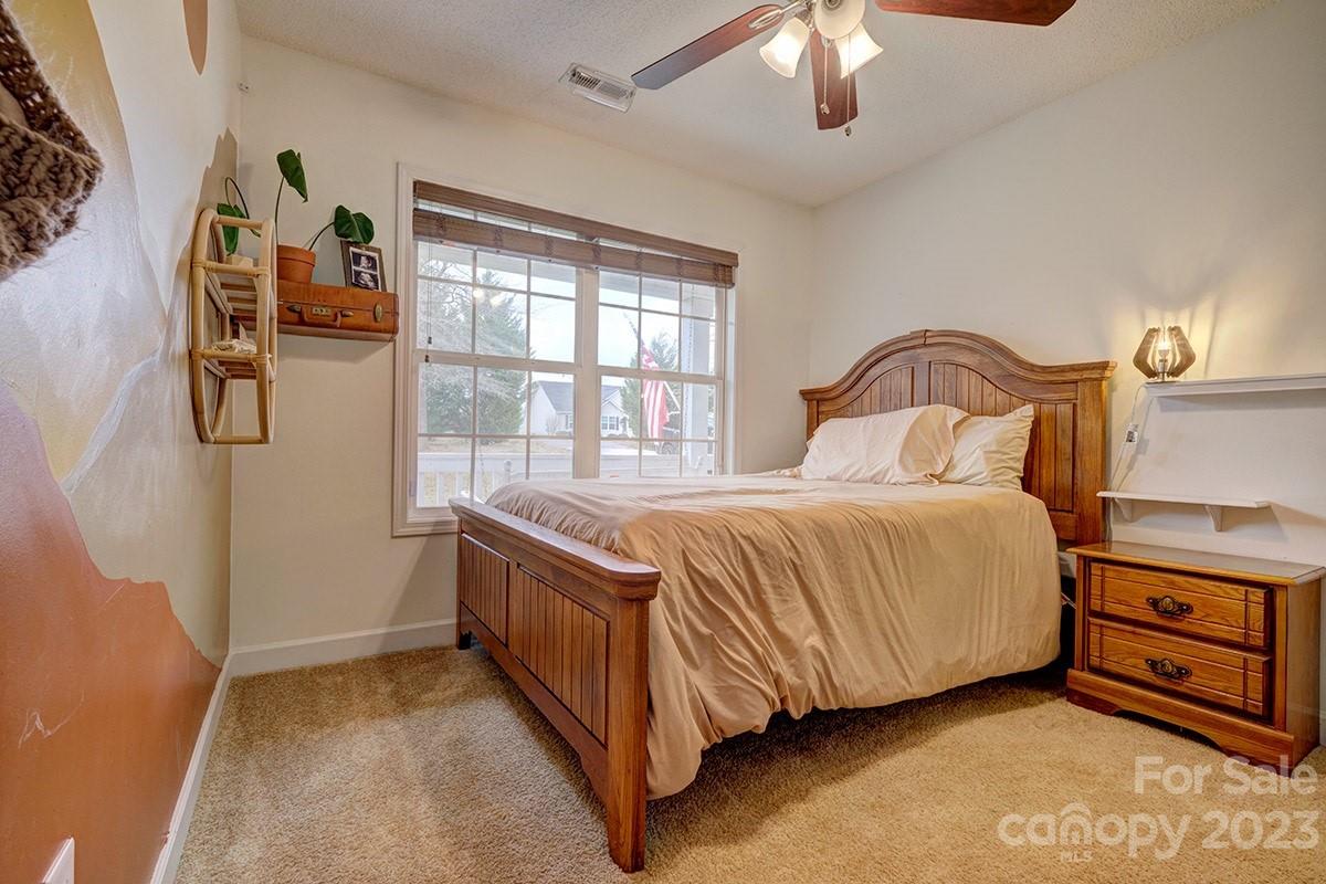 276 Springlake Road, Unit 6 York, SC 29745 - Photo 18 of 31 a spacious bedroom with a bed and a chandelier