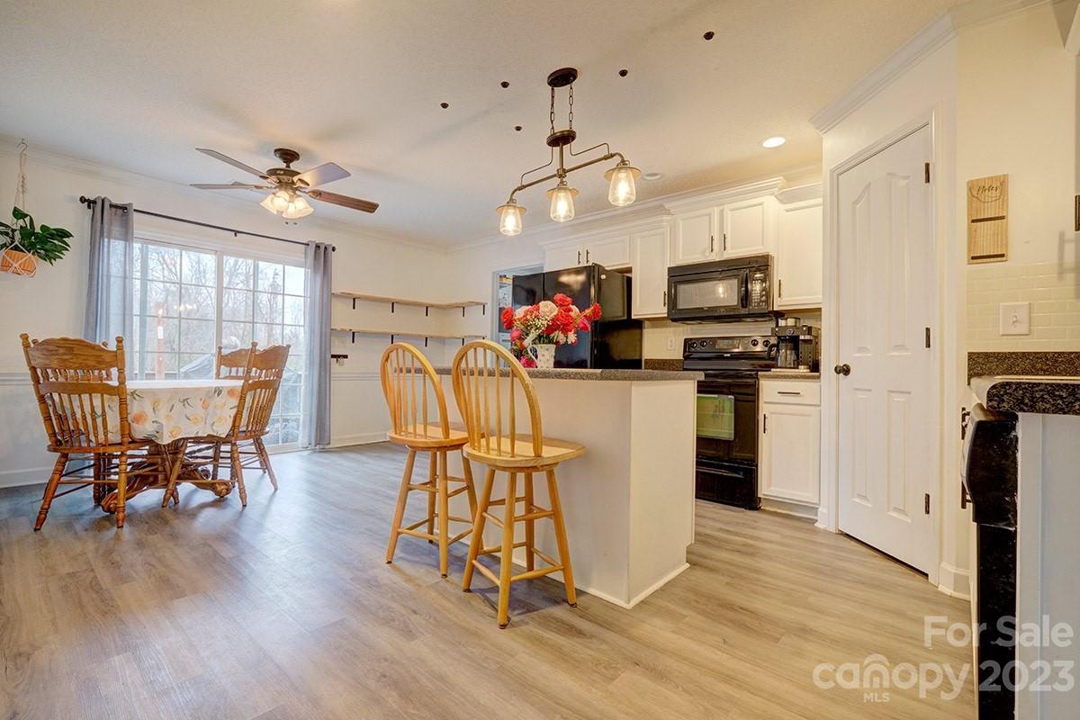 276 Springlake Road, Unit 6 York, SC 29745 - Photo 10 of 31 a view of a dining room with furniture and wooden floor