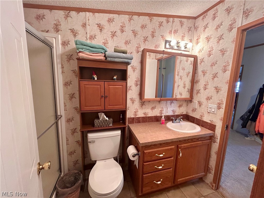 44501 Hanover Ridge Road Jewett, OH 43986 - Photo 10 of 33 Full bathroom with vanity, a shower with shower door, light tile patterned flooring, a textured ceiling, and light colored carpet