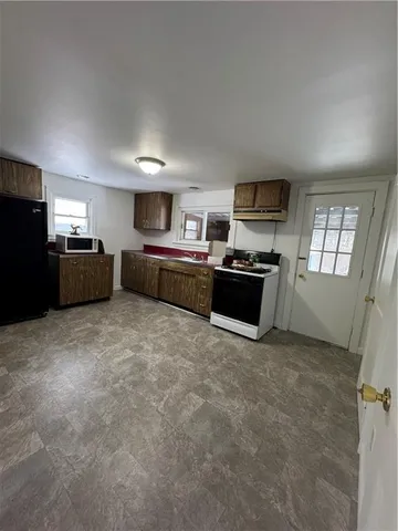a kitchen with refrigerator and windows