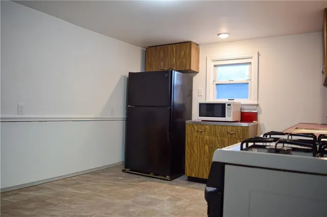 a kitchen with a refrigerator and a stove