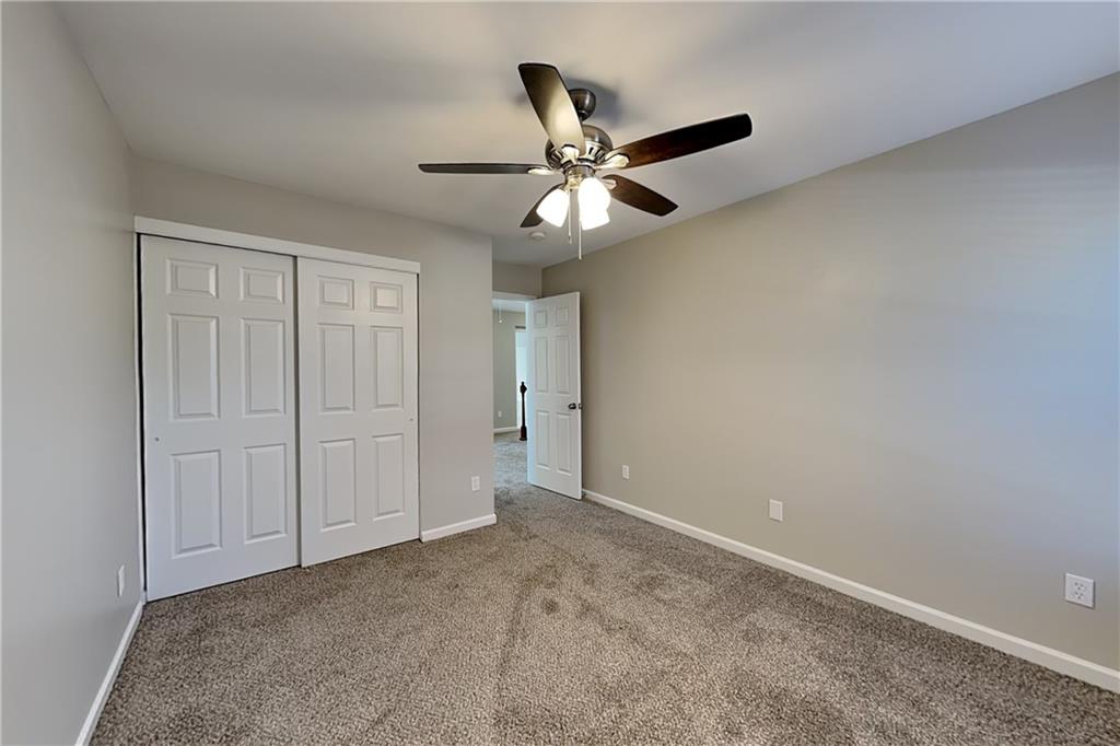 40 Parkmont Court Dallas, GA 30132 - Photo 11 of 19 an empty room with closet and a chandelier fan