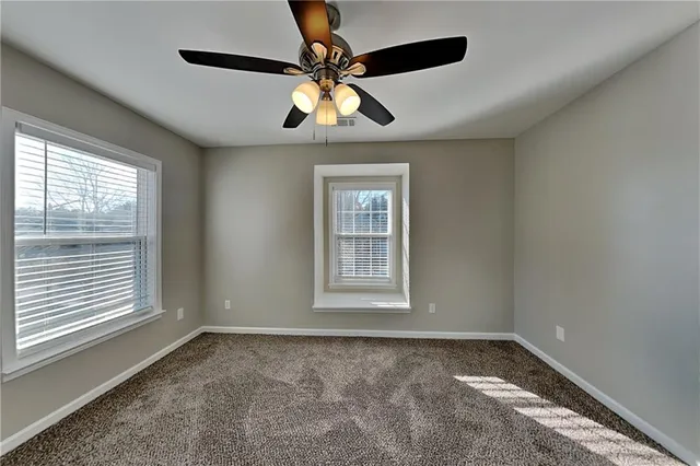 a view of a livingroom with a ceiling fan and window