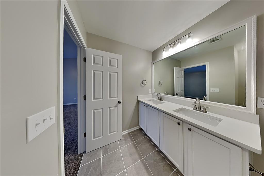 40 Parkmont Court Dallas, GA 30132 - Photo 8 of 19 a bathroom with a double vanity sink and mirror